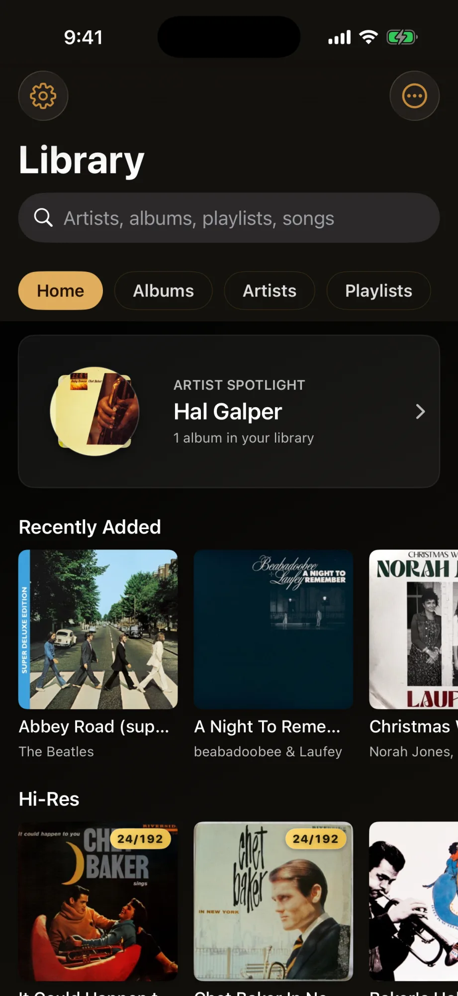 Kord's library on iPhone — an auto-organized Home view with an artist spotlight, recently added albums, and a hi-res shelf, all showing fetched artwork
